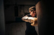 © Studio Marmellata/Stocksy - Focused strong woman boxing in gloves