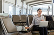 © Jayme Burrows/Stocksy - Business Woman on Laptop in the Airport