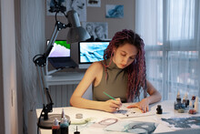 Young Female Illustrator Drawing Picture With Ink