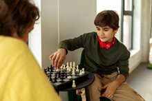 Kids Playing Chess In Playroom