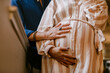 © ByLorena/Stocksy - Couple touching pregnancy belly at window