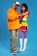 © BONNINSTUDIO/Stocksy - Fancy multiracial couple in bright outfits