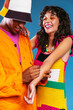 © BONNINSTUDIO/Stocksy - Multiracial creative couple in colorful clothes