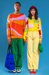 © BONNINSTUDIO/Stocksy - Serious multiracial couple in colorful outfits