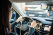 © Igor Kardasov/Stocksy - Woman driver using navigation system while driving car