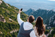 © Igor Kardasov/Stocksy - Couple making selfie on smartphone on mountain trip