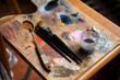 © Alba Vitta/Stocksy - Detail of paint and brushes at art  studio