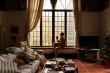 Portrait Of  Man Sitting By The Window With Coffe 