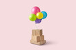 © Yaroslav Danylchenko/Stocksy - Cardboard boxes tied to colorful balloons