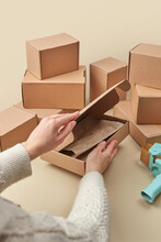 Close Up Of Female Hands Packing Parcel Box