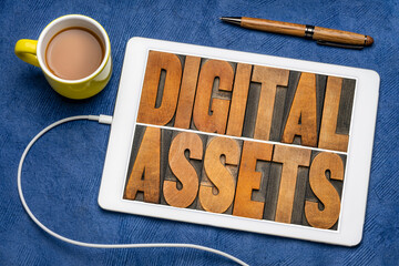 Canvas Print - digital assets word abstract in vintage letterpress wood type on a digital tablet, flat lay with cof