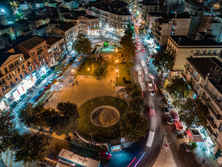 Panoramic aerial drone shot of the citylights of Corfu city at night. Kerkyra. Corfu island. Greece.