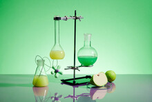 Laboratory Glass Equipment With Yellow And Green Water Ingredients On Green Background
