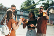 Group of friends drinking beer and having fun at music festival
