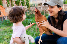 Woman And Kid With Chicken