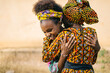 © Daniel Gonzalez/Stocksy - Cheerful African girls hugging on street