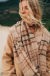 © Olga Moreira/Stocksy - Woman in scarf in the wind
