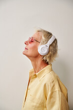 Elderly Woman In White Headphones,