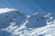 © Sonja Lekovic/Stocksy - mountain peak covered in snow and clear blue sky