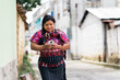 © Santi Nuñez/Stocksy - Guatemalan woman with her daughter using smartphone.