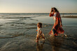 © Erin Brant/Stocksy - Mother and daughter wading in ocean