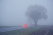 Leinwandbild Motiv car with fog lights on foggy country road