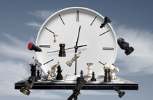 Chess Pieces, Chess Board And Clock On Sky Background