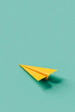 Yellow Paper Plane On Blue Background With Copy Space