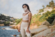 © bianca beltran/Stocksy - Portrait of a woman wearing activewear with a mask
