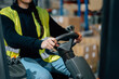 © Sergio Marcos/Stocksy - Anonymous storehouse worker riding electric forklift