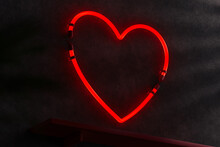 Neon Heart Inside On A Dark Wall