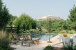 © Ali Harper/Stocksy - Lifestyle image of a luxury backyard pool