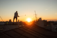 Silhouette Of A Golfer On The Roof At Sunset