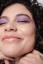 Model With  Curly Afro Hair And Purple Makeup