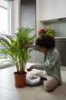 © Mauro Grigollo/Stocksy - Black woman caring for plants