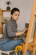© STUDIO TAURUS/Stocksy - Young female art student painting at home