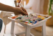 Anonymous Woman In Art Studio Holding Paint Brush