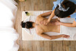© STUDIO TAURUS/Stocksy - Overhead view of unknown female having a massage at Spa