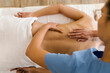 © STUDIO TAURUS/Stocksy - Masseuse massaging a client at spa