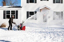 Man Clears Snow Using Snowblower After Big Storm