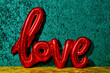 © Juan Moyano/Stocksy - red balloon in the shape of the word love