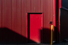 An Entrance In An Red Colored Aluminum Building
