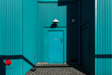 An Entrance In An Aqua Colored Aluminum Building