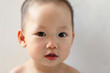 © ChaoShu Li/Stocksy - Close up funny expression of cute little Asian baby