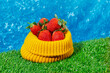 © Juan Moyano/Stocksy - knitted bag with some strawberries