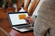 © Malquerida Studio/Stocksy - Hand with credit card and laptop