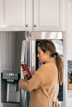 Kitchen: Woman Peers Into Refrigerator