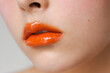 © Ángela Rober/Stocksy - Close-up photo of moisturized lips painted orange