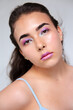 © Ángela Rober/Stocksy - Young woman with fantasy violet and blue make up
