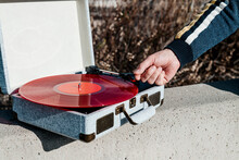 Plays A Disc In A Portable Turntable Outdoors
